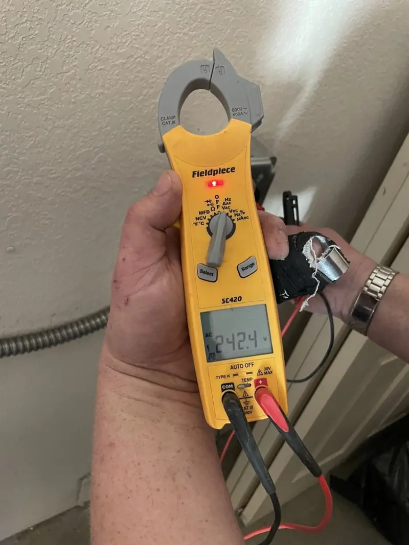 Voltage testing with clamp meter during Electrical Installation Services in Lely